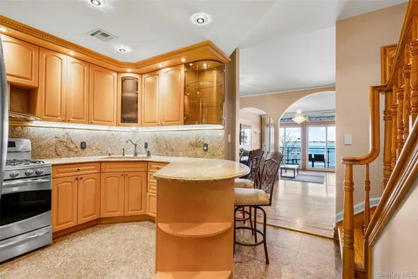 a kitchen with granite countertop a sink stove and cabinets