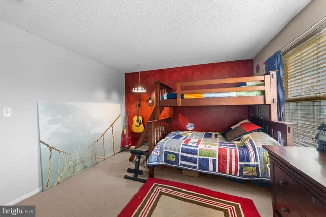 a bedroom with furniture and a window