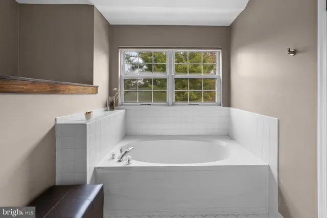 a bathroom with double vanity sinks and a mirror