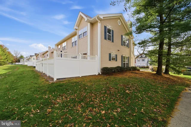 a front view of a house with garden and sitting area