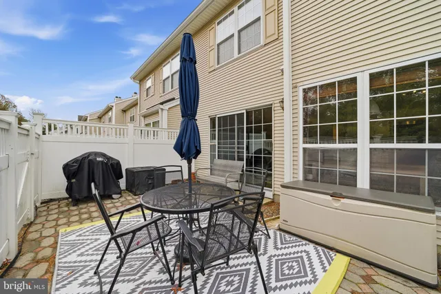 a view of a patio with a table and chairs