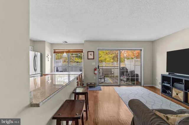 a kitchen with granite countertop white cabinets and stainless steel appliances