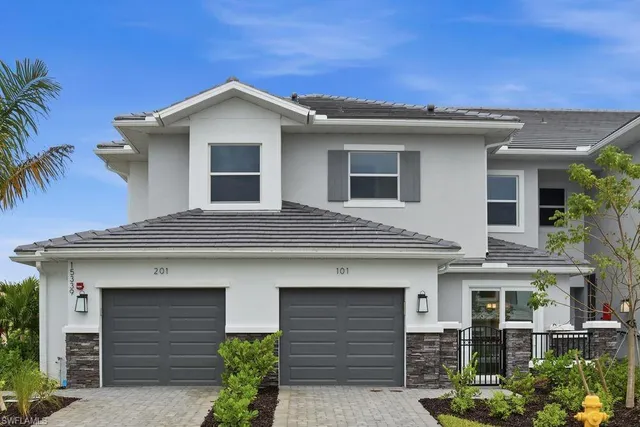a front view of a house with garage
