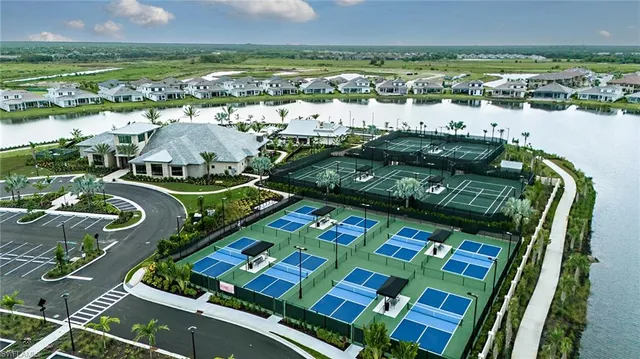 a view of a chairs and table in patio with a lake view