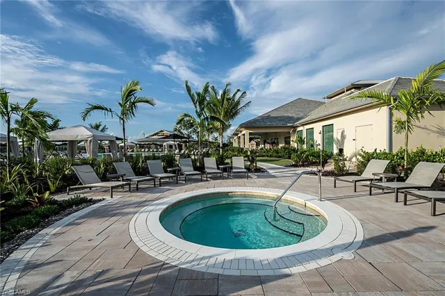 a view of a swimming pool with an outdoor seating