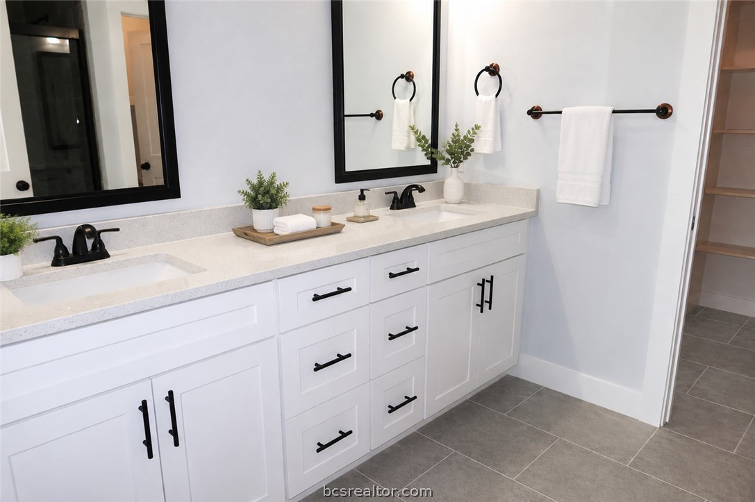 2012 Reagan Court Bryan, TX 77802 - Photo 13 of 19 a bathroom with a double vanity sink and mirror