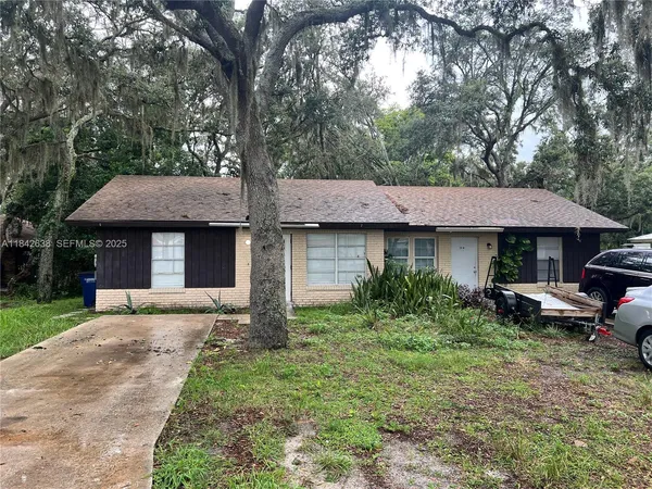 a view of a house with a yard and sitting area