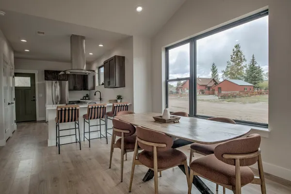 a dining room with furniture and wooden floor