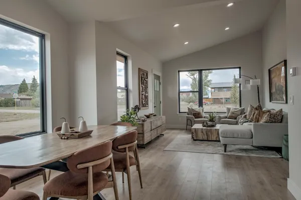 a living room with furniture and large windows