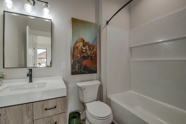 a bathroom with a toilet sink and bathtub