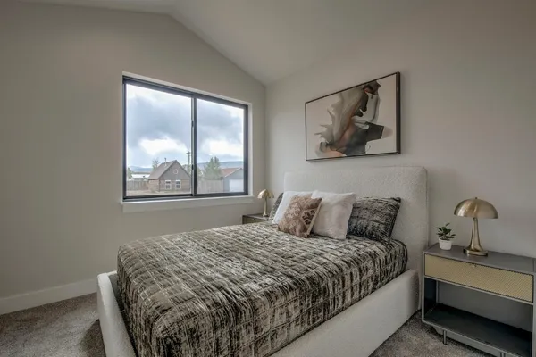 a bedroom with a bed and a painting on the wall