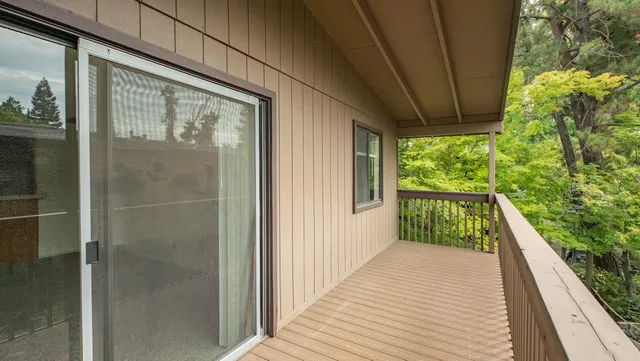 a view of balcony with wooden floor
