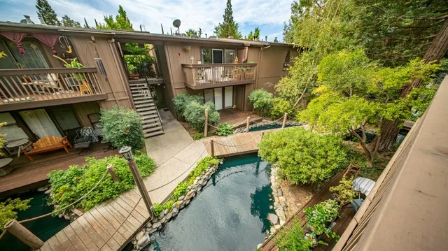 a view of a house with brick walls and flower plants