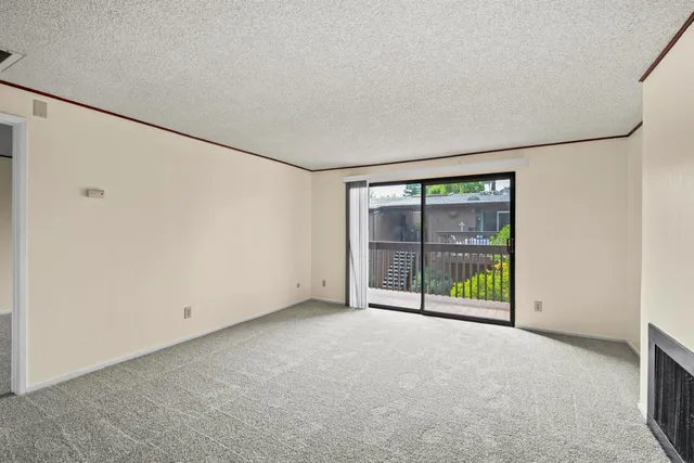 a view of an empty room with a sliding door