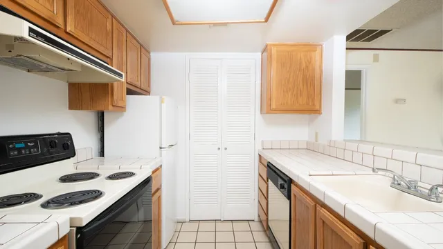 a kitchen with a sink stove and refrigerator