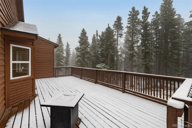 a view of balcony with wooden floor and fence