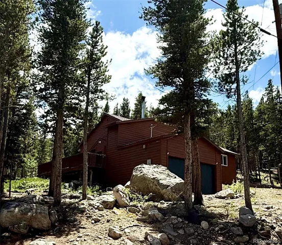 a view of a house with a yard and mountain view