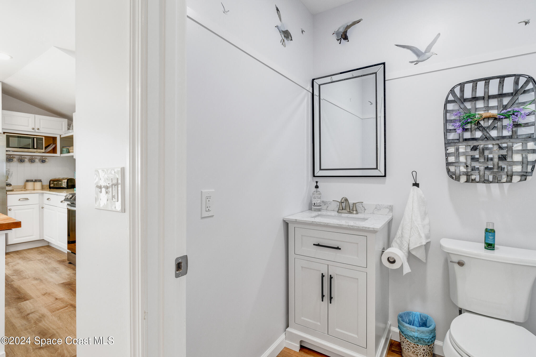 4055 Palm Avenue Micco, FL 32976 - Photo 13 of 58 a bathroom with a toilet a sink and a mirror