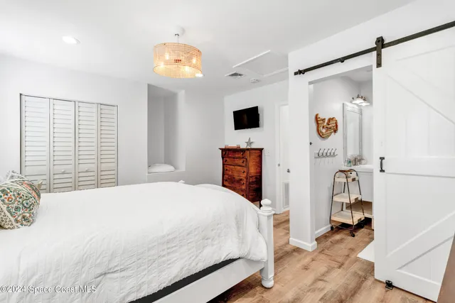 a bedroom with furniture and a window