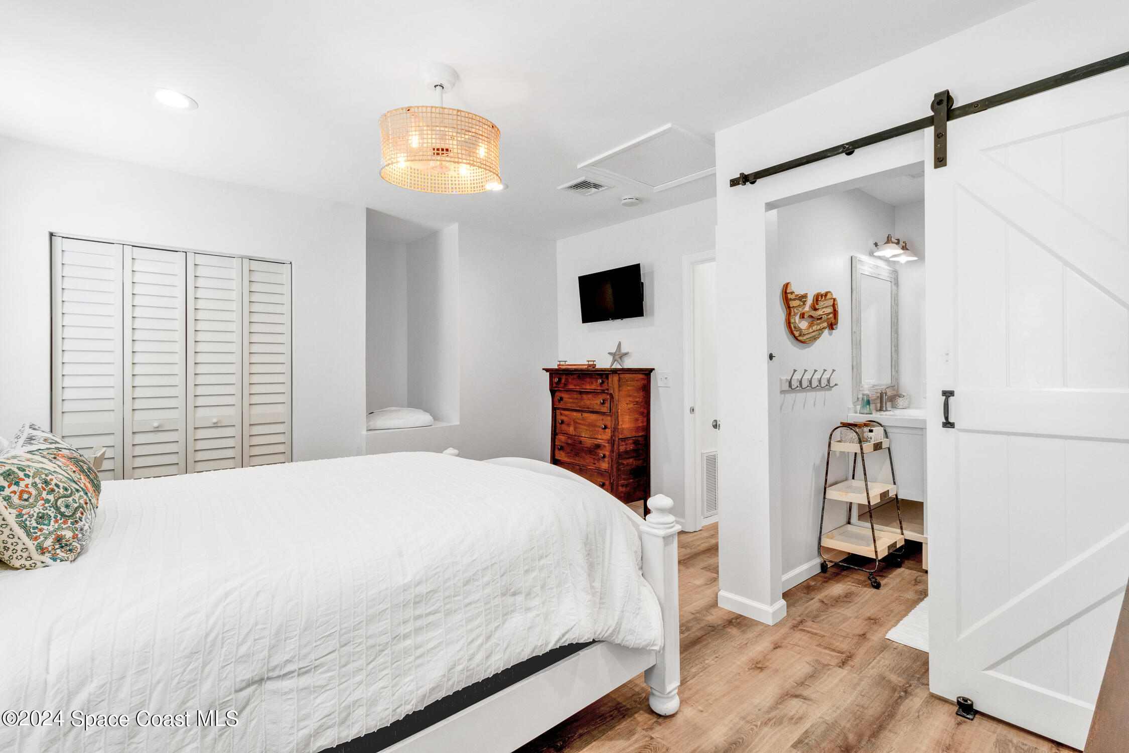 4055 Palm Avenue Micco, FL 32976 - Photo 15 of 58 a bedroom with a bed and a chandelier