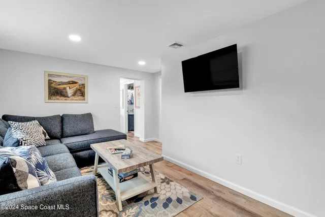 a bedroom with a large bed and a flat screen tv