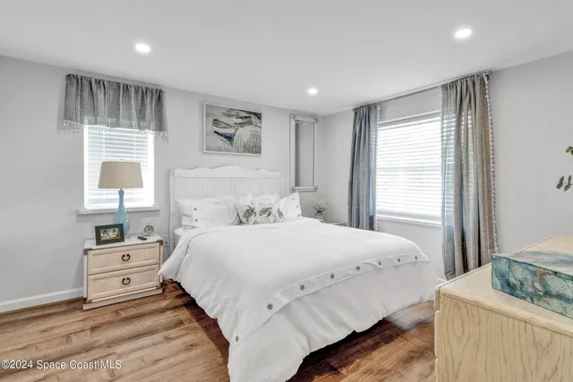 a bedroom with two beds and a dresser