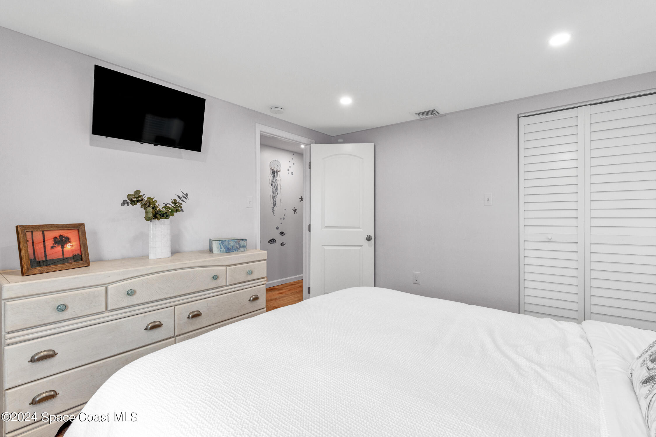 4055 Palm Avenue Micco, FL 32976 - Photo 22 of 58 a bedroom with a large bed and a flat screen tv