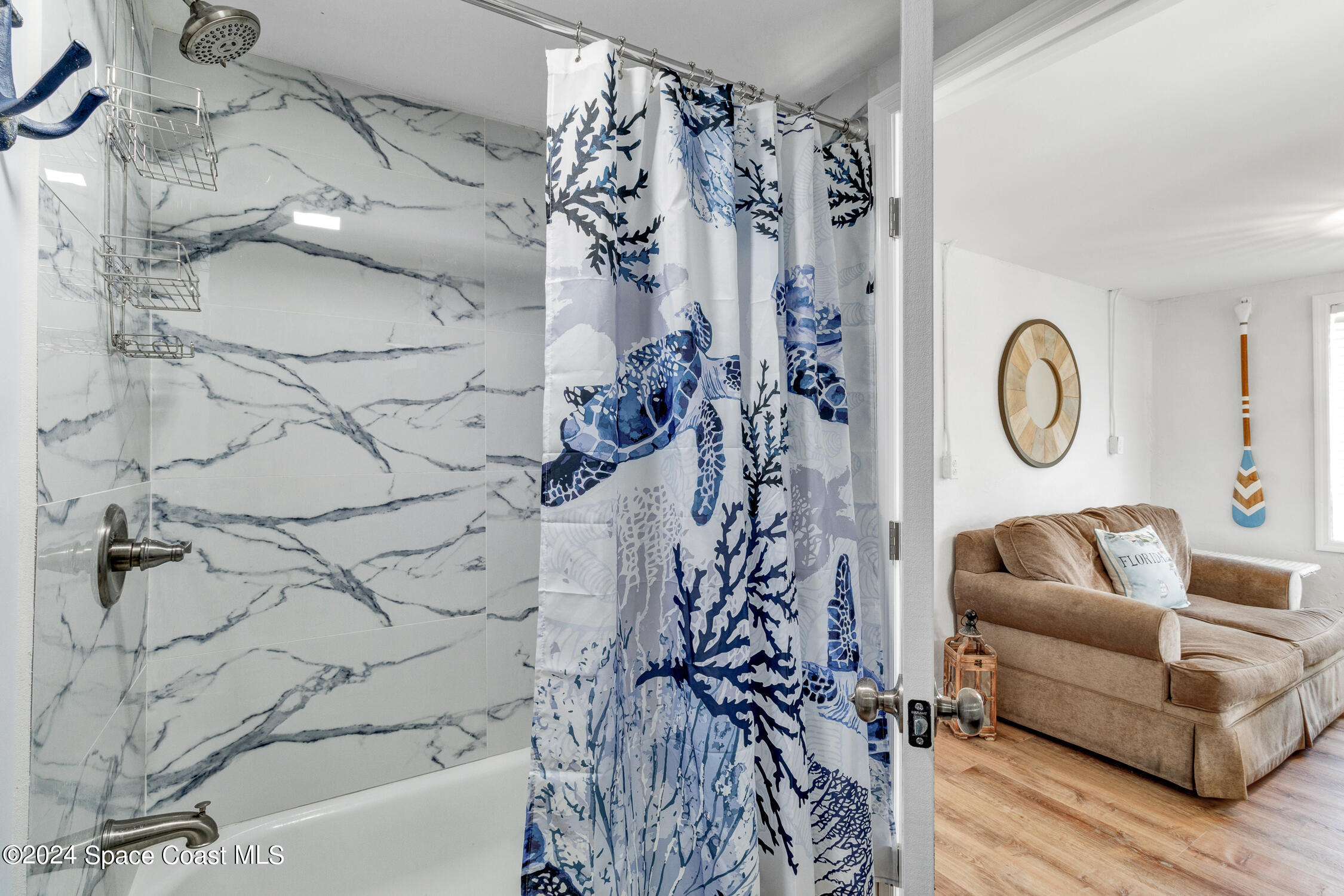 4055 Palm Avenue Micco, FL 32976 - Photo 24 of 58 a living room with a couch and a chandelier