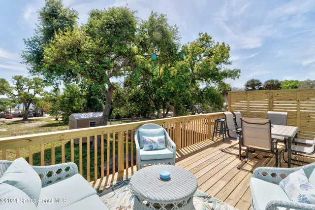 a view of backyard with barbeque grill and outdoor seating