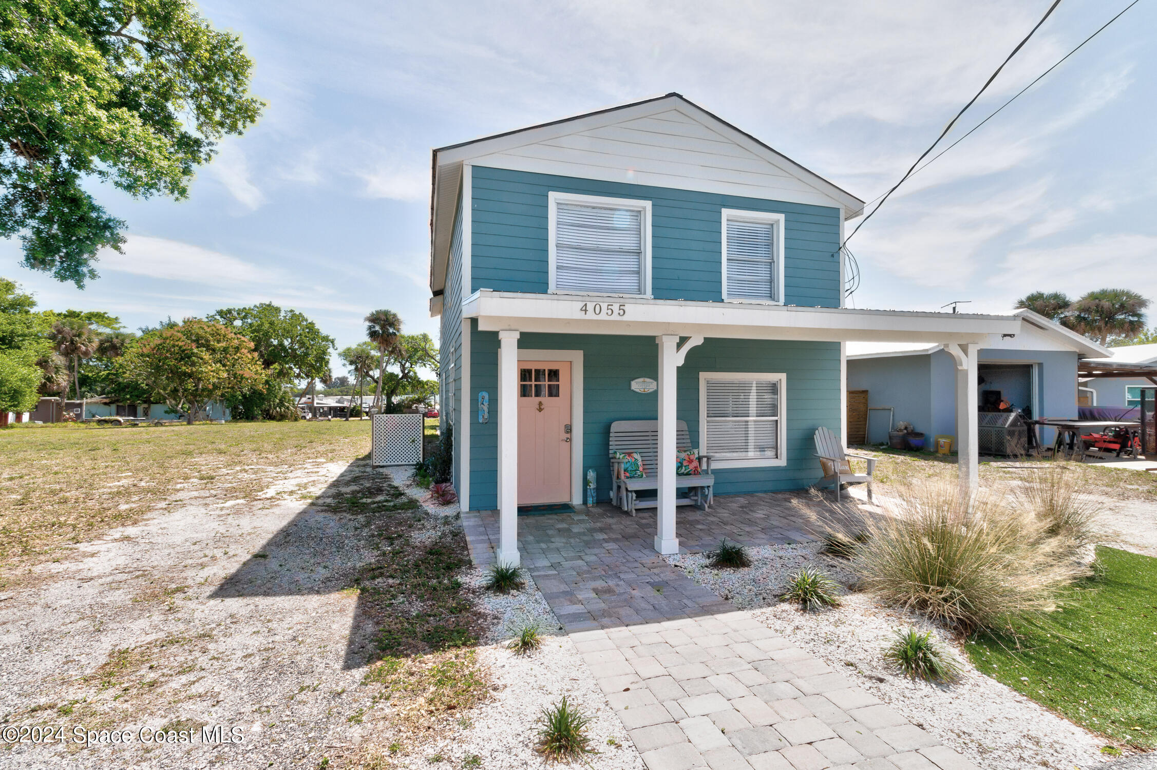 4055 Palm Avenue Micco, FL 32976 - Photo 3 of 58 a front view of a house with a yard and potted plants