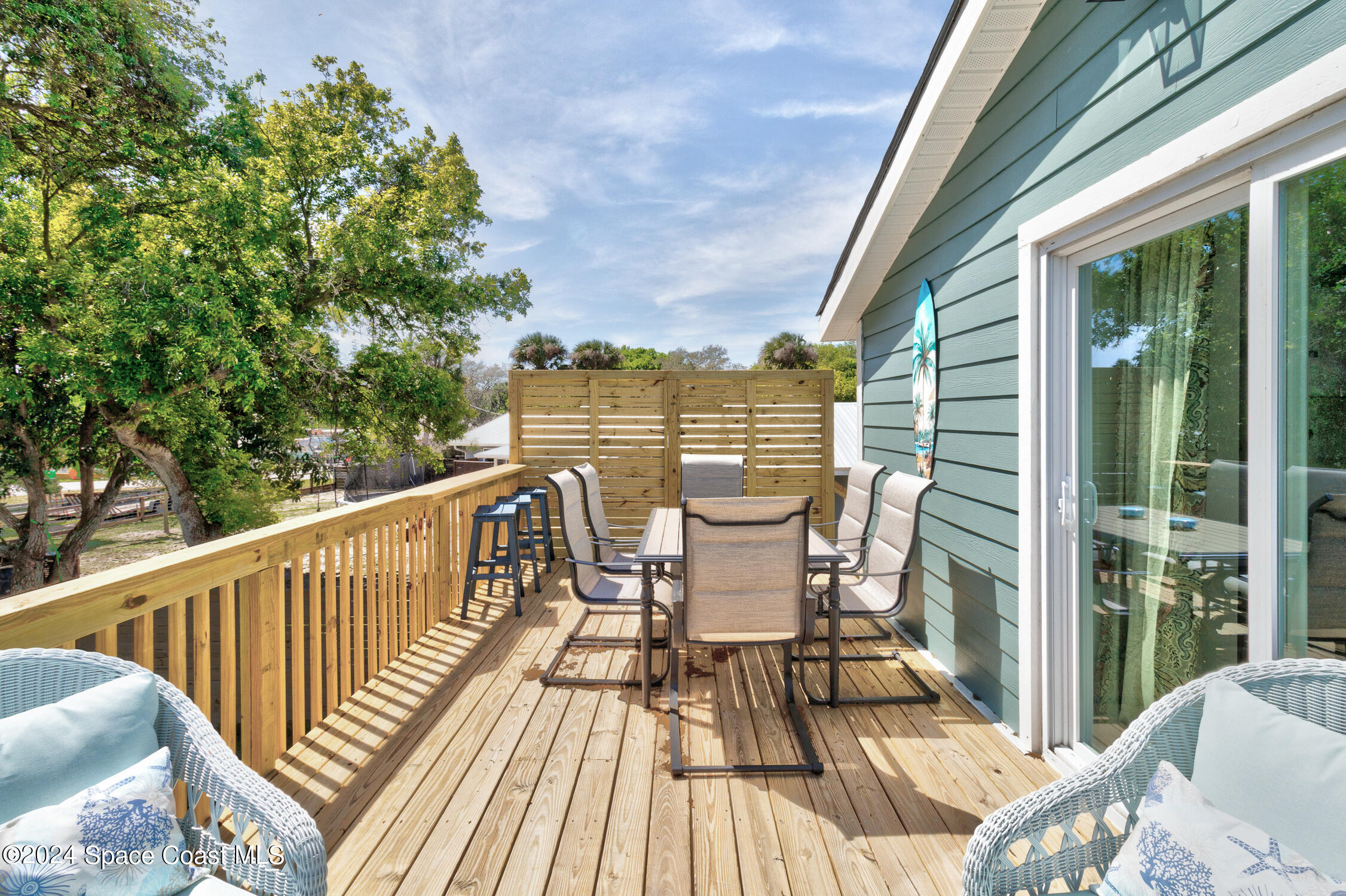 4055 Palm Avenue Micco, FL 32976 - Photo 31 of 58 a view of a balcony with wooden floor and outdoor seating