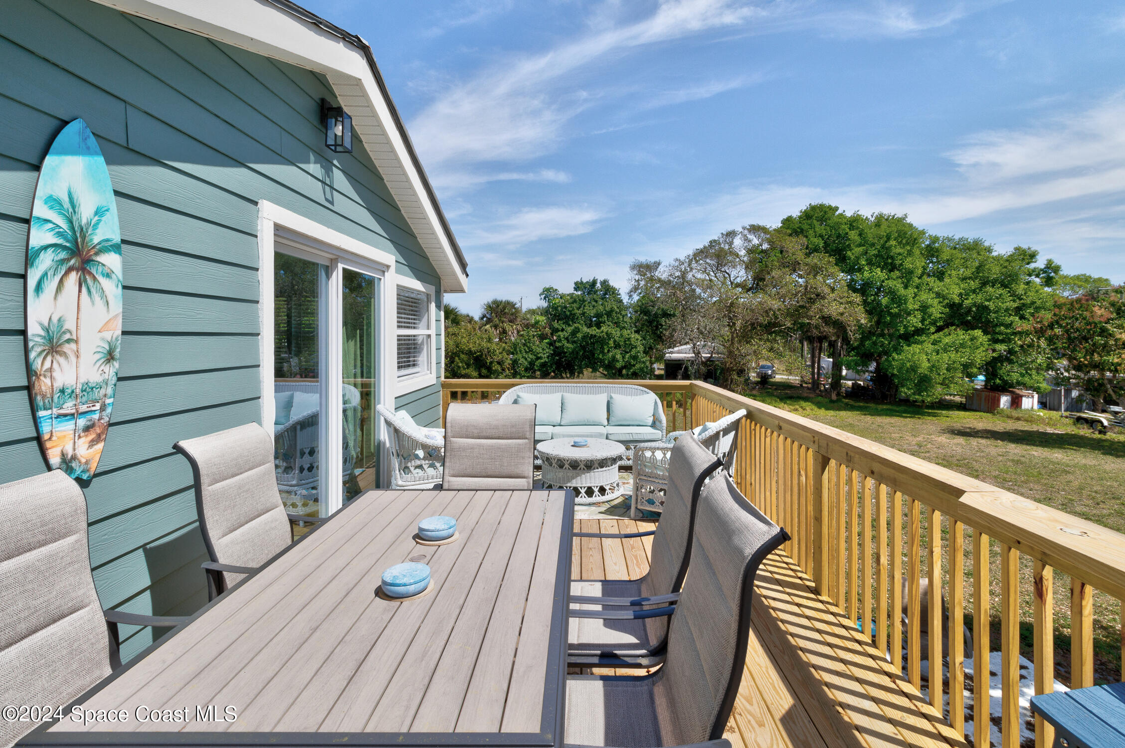 4055 Palm Avenue Micco, FL 32976 - Photo 32 of 58 a balcony with wooden floor and outdoor seating