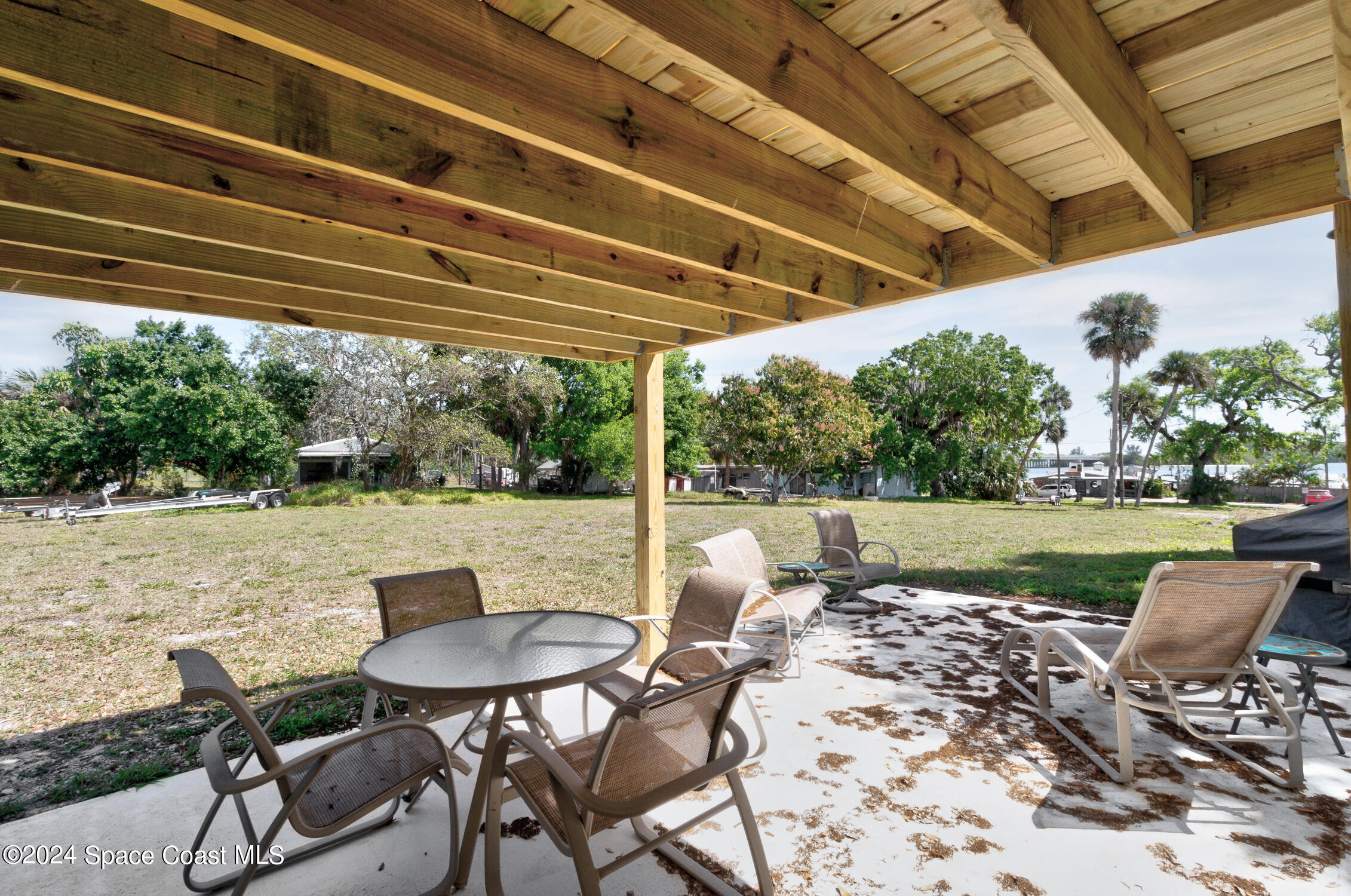 4055 Palm Avenue Micco, FL 32976 - Photo 33 of 58 a view of a patio with table and chairs and potted plants