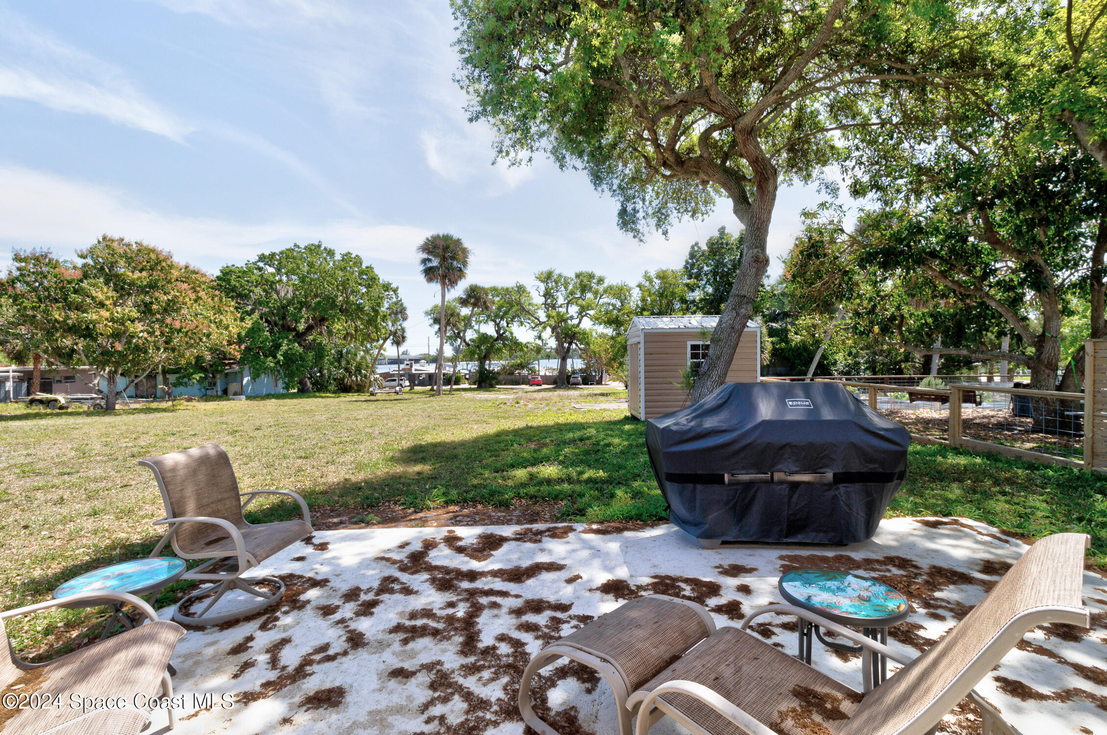 4055 Palm Avenue Micco, FL 32976 - Photo 35 of 58 a view of backyard with deck and outdoor seating