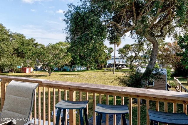 a view of a patio with table and chairs
