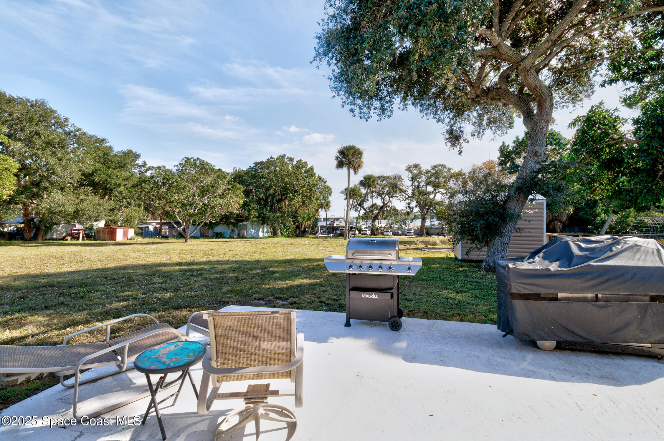 4055 Palm Avenue Micco, FL 32976 - Photo 48 of 58 a view of a swimming pool and lounge chairs in back yard of the house