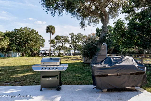an aerial view of a house with a yard and lake view