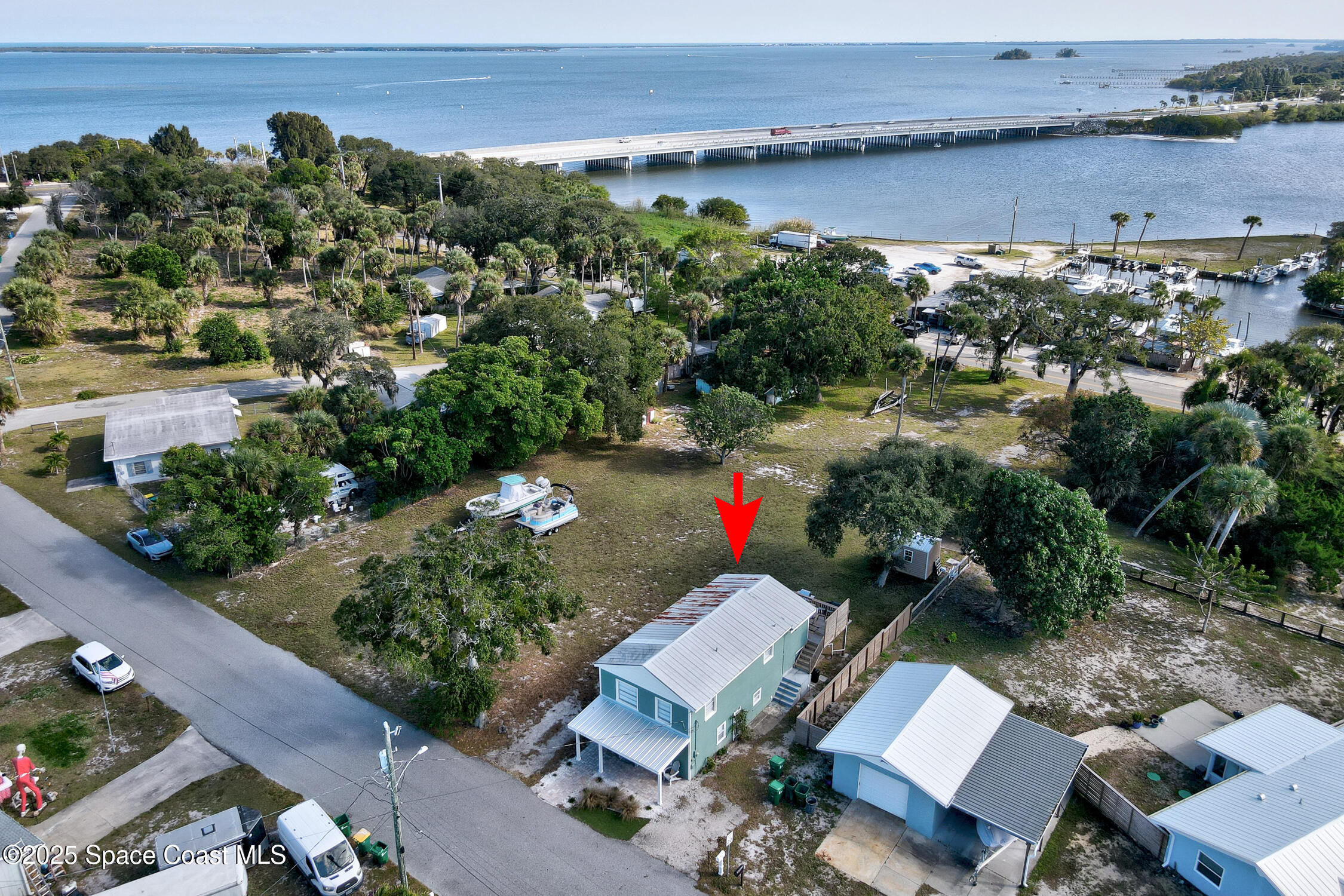 4055 Palm Avenue Micco, FL 32976 - Photo 57 of 58 an aerial view of a house with a yard and lake view
