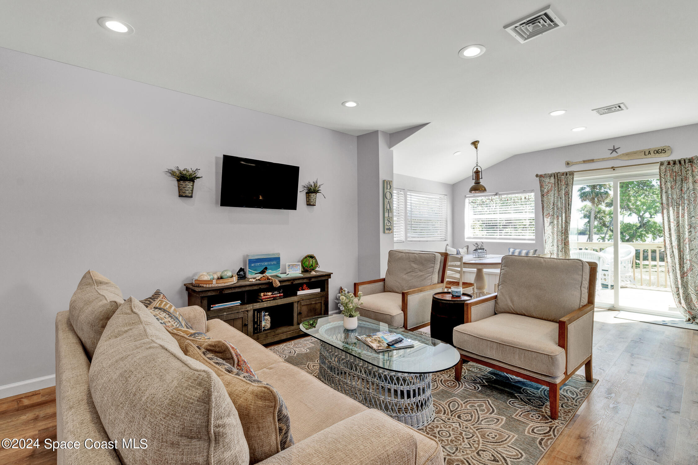4055 Palm Avenue Micco, FL 32976 - Photo 7 of 58 a living room with furniture and a flat screen tv