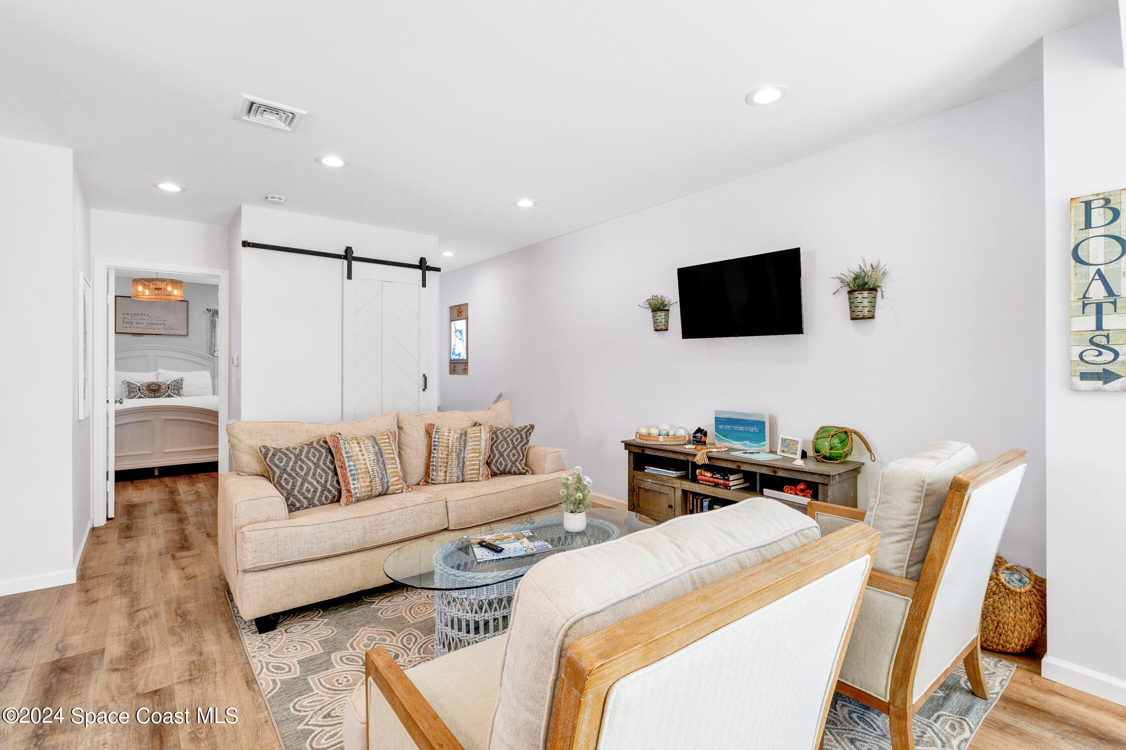 4055 Palm Avenue Micco, FL 32976 - Photo 8 of 58 a living room with furniture and a flat screen tv