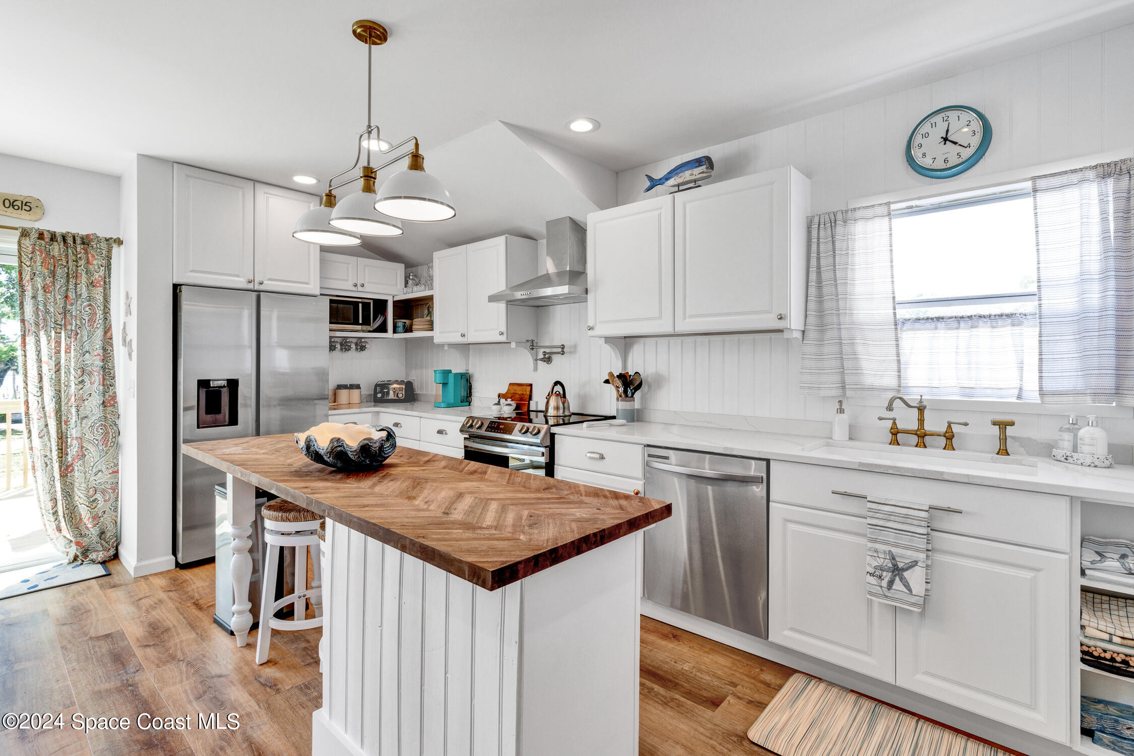 4055 Palm Avenue Micco, FL 32976 - Photo 9 of 58 a kitchen with a stove a sink a refrigerator and cabinets