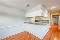 a kitchen with kitchen island a sink a stove and a refrigerator