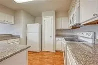 a kitchen with a sink stove and refrigerator