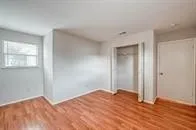 a view of a room with wooden floor and windows
