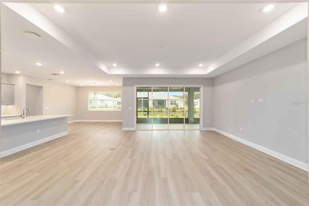 10305 Southwest 105th Street Ocala, FL 34481 - Photo 11 of 44 an empty room with wooden floor and windows