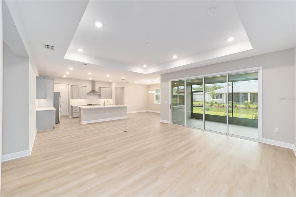 10305 Southwest 105th Street Ocala, FL 34481 - Photo 12 of 44 a view of an empty room with a window and wooden floor