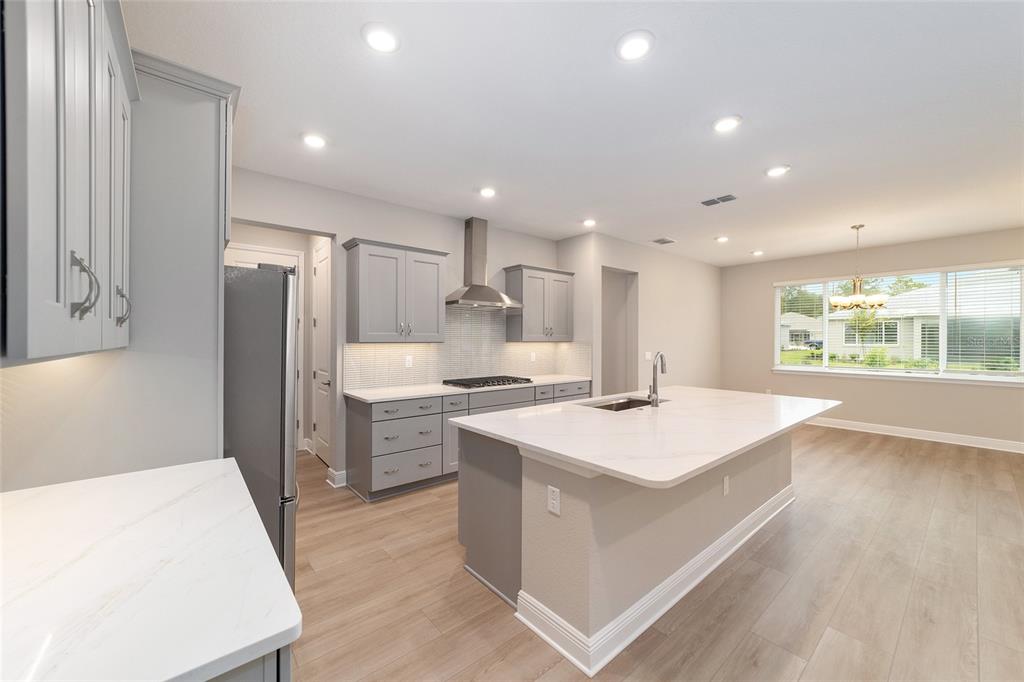 10305 Southwest 105th Street Ocala, FL 34481 - Photo 21 of 44 a kitchen with a stove a sink and a refrigerator