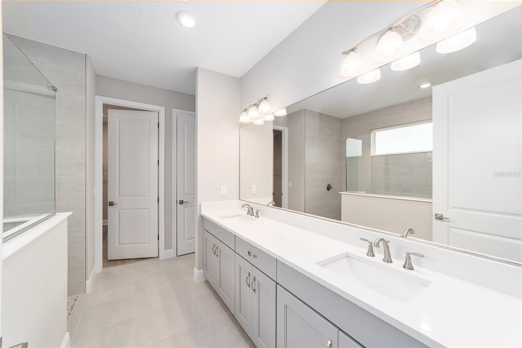 10305 Southwest 105th Street Ocala, FL 34481 - Photo 26 of 44 a bathroom with a double vanity sink mirror and double