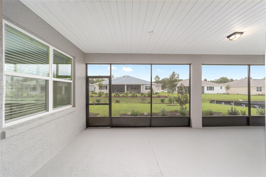 10305 Southwest 105th Street Ocala, FL 34481 - Photo 37 of 44 a view of an empty room with wooden floor and windows