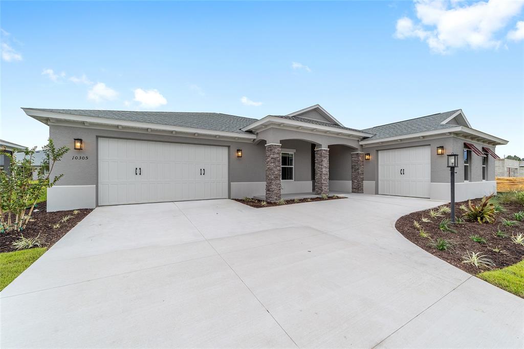 10305 Southwest 105th Street Ocala, FL 34481 - Photo 6 of 44 a front view of a house with a garage